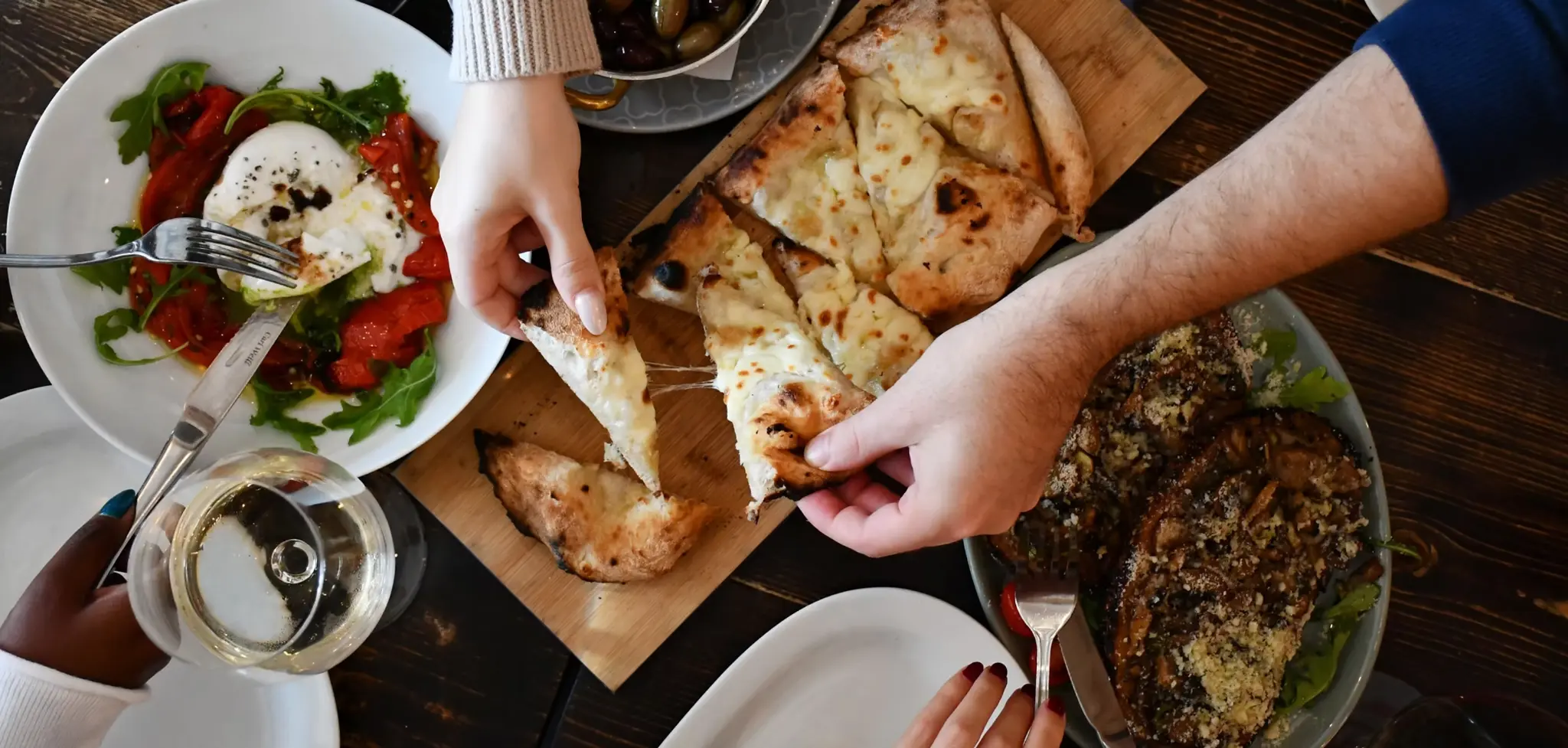 Guests sharing a meal at Pizza e Pazzi